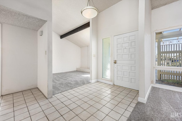 entryway featuring light colored carpet, lofted ceiling with beams, and a wealth of natural light