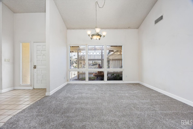 interior space featuring a textured ceiling and a chandelier