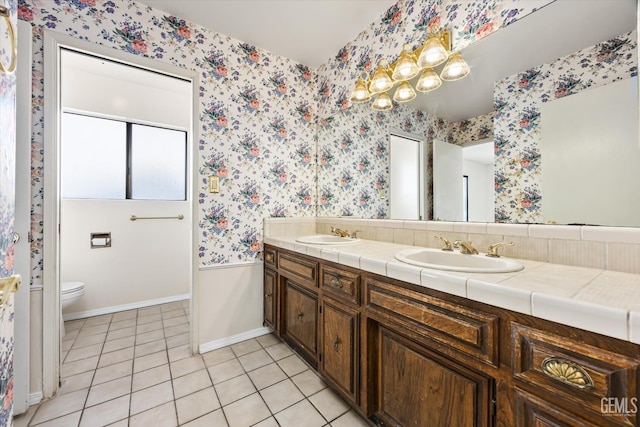 bathroom featuring toilet, tile patterned flooring, and vanity