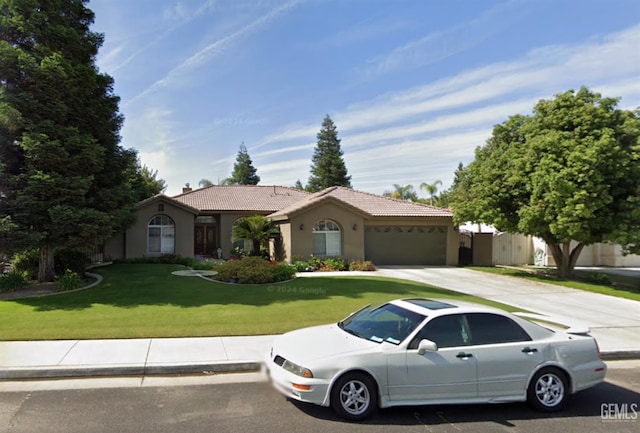 10723 Iron Creek Ave, Bakersfield, CA 93312 - view of front of house with an attached garage, stucco siding, a tile roof, concrete driveway, and a front lawn