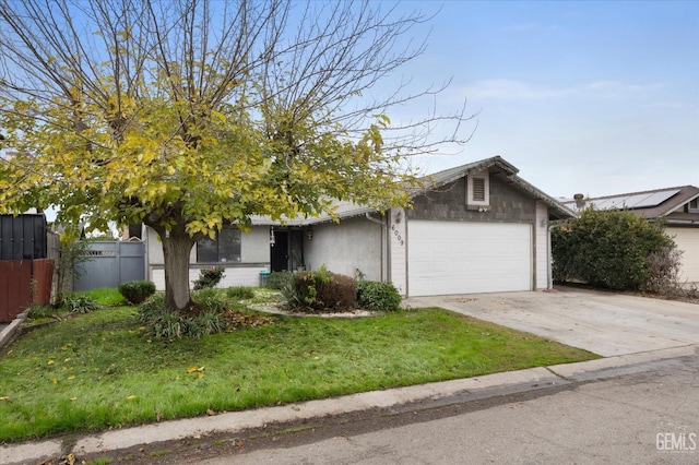 view of front of property featuring a garage and a front yard