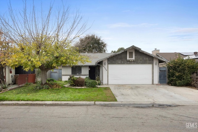 view of front of property featuring a garage and a front lawn