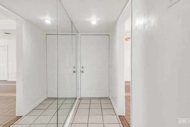 corridor with light tile patterned floors