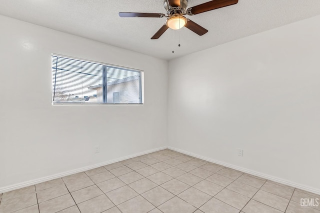 tiled empty room featuring ceiling fan and a textured ceiling