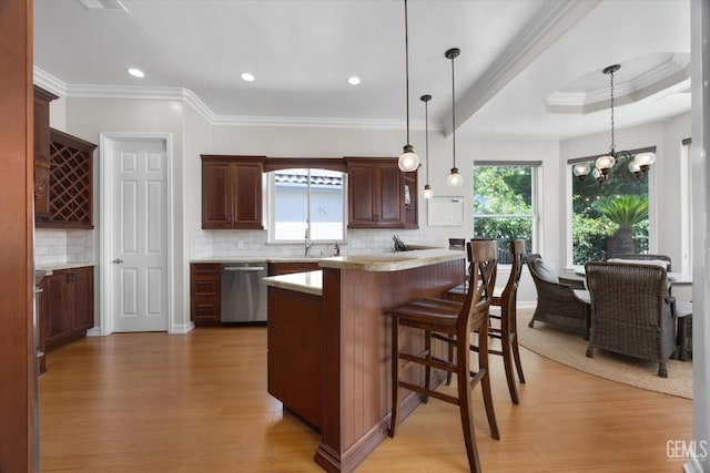 2120 Wedgemont Pl, Bakersfield, CA 93311 - kitchen with dishwasher, a kitchen bar, tasteful backsplash, ornamental molding, and light wood-style floors