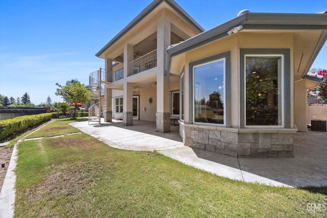 2120 Wedgemont Pl, Bakersfield, CA 93311 - back of property featuring a patio area, ceiling fan, stucco siding, stone siding, and a balcony