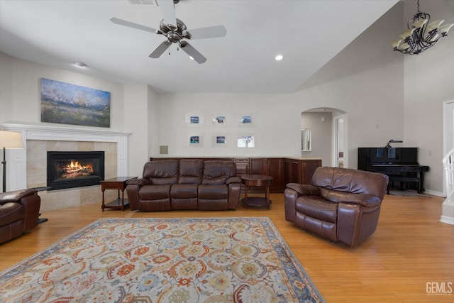 2120 Wedgemont Pl, Bakersfield, CA 93311 - living room with arched walkways, ceiling fan, light wood-style floors, a fireplace, and recessed lighting