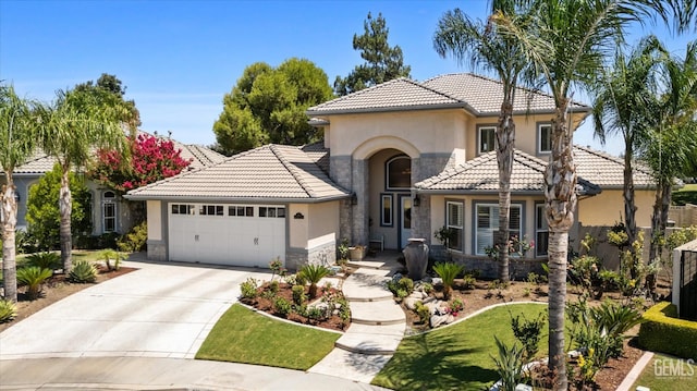 2120 Wedgemont Pl, Bakersfield, CA 93311 - mediterranean / spanish home with stone siding, stucco siding, an attached garage, a tile roof, and concrete driveway