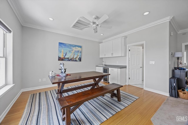 2120 Wedgemont Pl, Bakersfield, CA 93311 - dining area with beverage cooler, light wood-style flooring, a ceiling fan, crown molding, and recessed lighting
