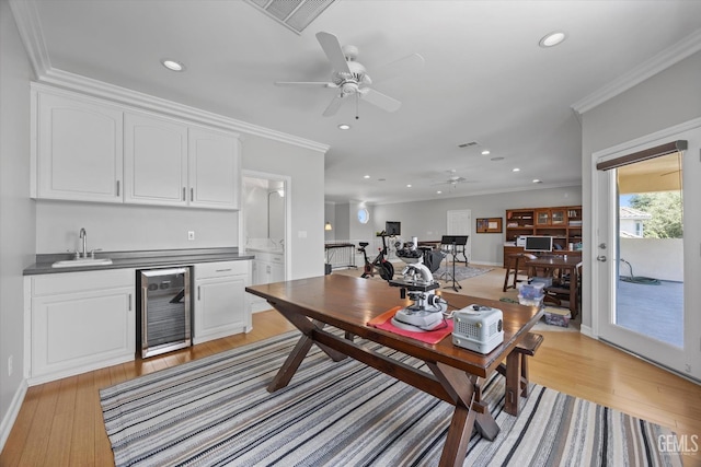 2120 Wedgemont Pl, Bakersfield, CA 93311 - living room featuring beverage cooler, bar with sink, a ceiling fan, light wood-style flooring, and recessed lighting