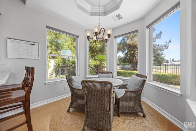 2120 Wedgemont Pl, Bakersfield, CA 93311 - dining space featuring light wood-type flooring, a chandelier, a raised ceiling, and crown molding