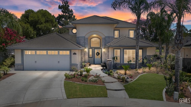 2120 Wedgemont Pl, Bakersfield, CA 93311 - mediterranean / spanish-style home featuring stone siding, a tiled roof, an attached garage, concrete driveway, and stucco siding