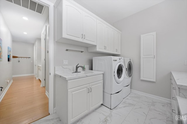 2120 Wedgemont Pl, Bakersfield, CA 93311 - washroom featuring light marble finish flooring, washing machine and dryer, cabinet space, and recessed lighting