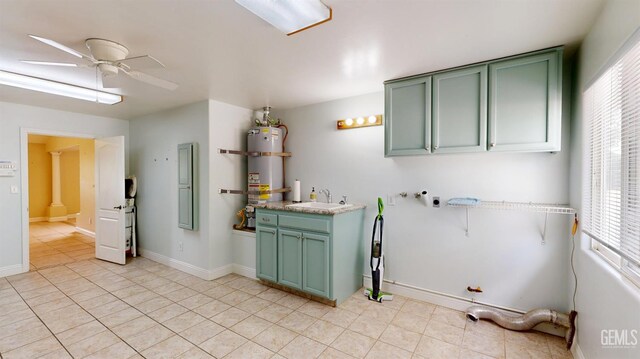 1334 Renfro Rd, Bakersfield, CA 93314 - laundry area featuring secured water heater, light tile patterned floors, a ceiling fan, and baseboards