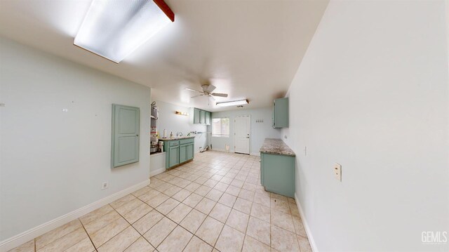 1334 Renfro Rd, Bakersfield, CA 93314 - unfurnished living room with light tile patterned floors, baseboards, and ceiling fan