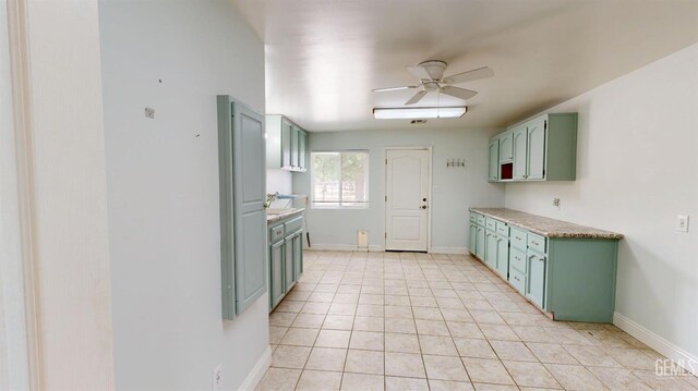1334 Renfro Rd, Bakersfield, CA 93314 - kitchen with green cabinets, ceiling fan, light tile patterned floors, and light countertops