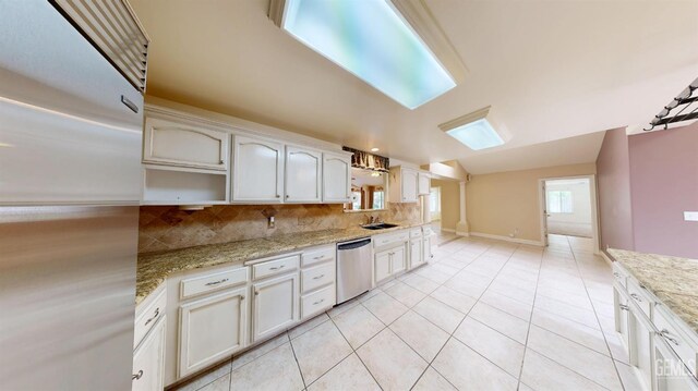 1334 Renfro Rd, Bakersfield, CA 93314 - kitchen with stainless steel appliances, a sink, backsplash, light tile patterned floors, and light stone counters