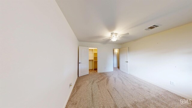 1334 Renfro Rd, Bakersfield, CA 93314 - unfurnished bedroom featuring light colored carpet, baseboards, a walk in closet, and a ceiling fan
