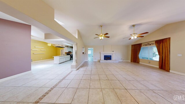 1334 Renfro Rd, Bakersfield, CA 93314 - unfurnished living room with a fireplace with raised hearth, ceiling fan, vaulted ceiling, and baseboards