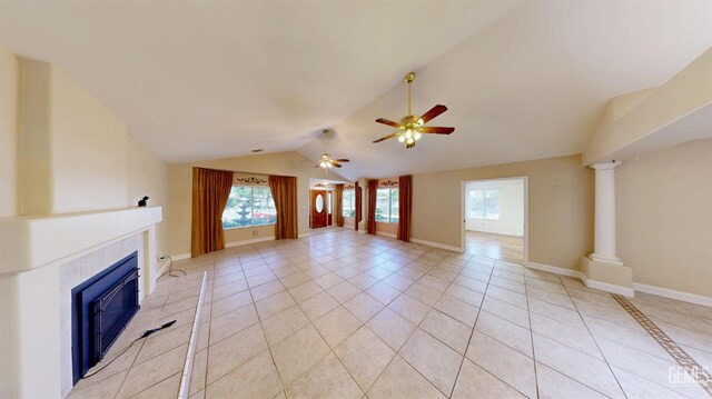 1334 Renfro Rd, Bakersfield, CA 93314 - unfurnished living room featuring healthy amount of natural light, vaulted ceiling, a tiled fireplace, ceiling fan, and light tile patterned floors