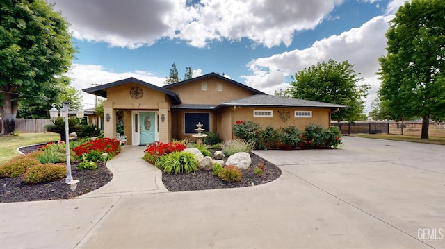 1334 Renfro Rd, Bakersfield, CA 93314 - view of front of property featuring fence, stucco siding, and concrete driveway