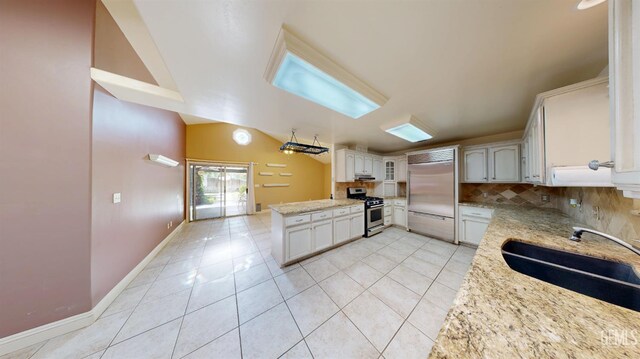 1334 Renfro Rd, Bakersfield, CA 93314 - kitchen featuring appliances with stainless steel finishes, a sink, decorative backsplash, light tile patterned flooring, and light stone countertops
