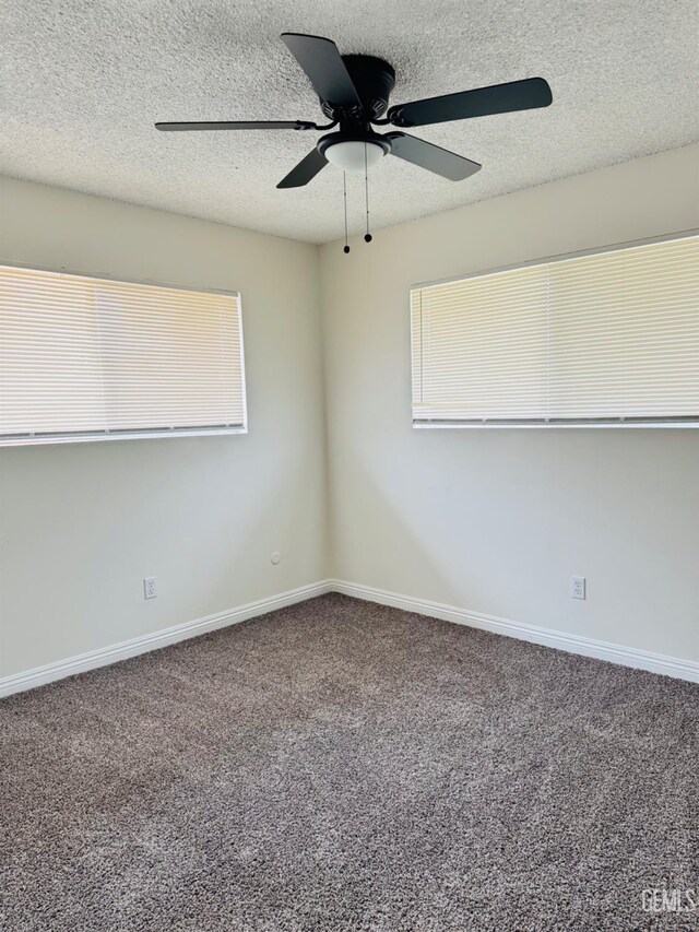 123 Ferguson Ave, Bakersfield, CA 93308 - carpeted empty room with a healthy amount of sunlight, a textured ceiling, baseboards, and ceiling fan