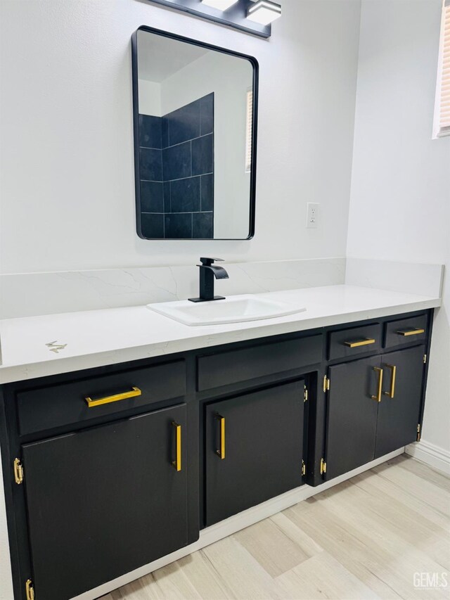 123 Ferguson Ave, Bakersfield, CA 93308 - bathroom featuring wood finished floors and vanity