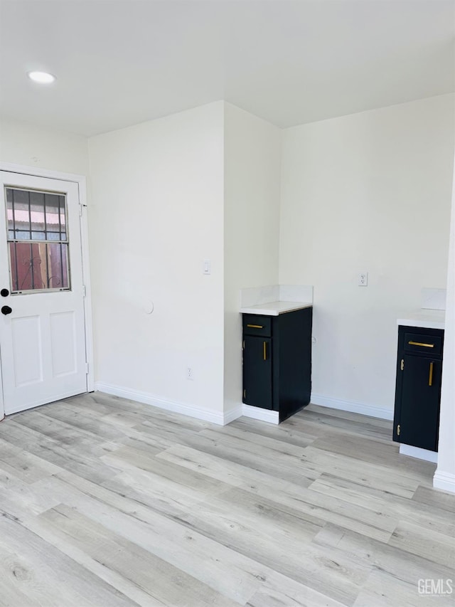 123 Ferguson Ave, Bakersfield, CA 93308 - unfurnished living room with baseboards and light wood-type flooring