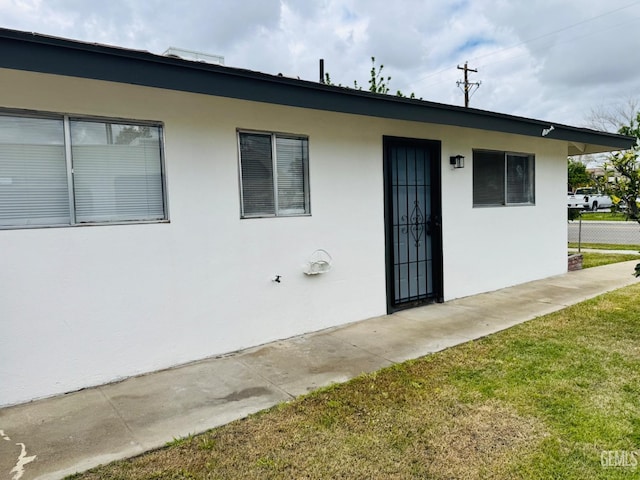 123 Ferguson Ave, Bakersfield, CA 93308 - exterior space featuring a lawn, stucco siding, and fence