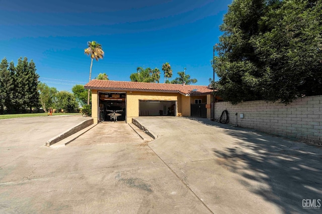854 Vineland Rd, Bakersfield, CA 93306 - view of front facade with a garage, a tile roof, stucco siding, and concrete driveway