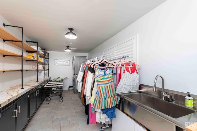 854 Vineland Rd, Bakersfield, CA 93306 - walk in closet featuring a sink and stone finish floors