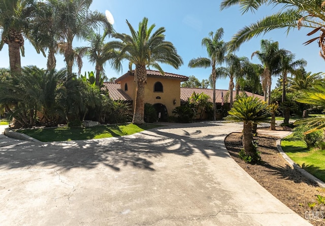 854 Vineland Rd, Bakersfield, CA 93306 - mediterranean / spanish-style house with a tile roof, curved driveway, and stucco siding