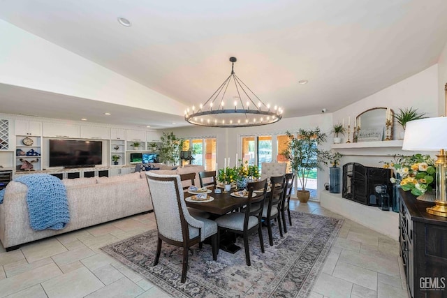 854 Vineland Rd, Bakersfield, CA 93306 - dining room with lofted ceiling, a chandelier, recessed lighting, and a fireplace with raised hearth