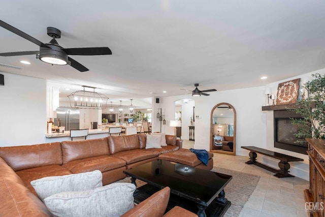 854 Vineland Rd, Bakersfield, CA 93306 - living room with a ceiling fan, a fireplace, arched walkways, and recessed lighting