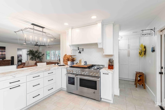 854 Vineland Rd, Bakersfield, CA 93306 - kitchen featuring range with two ovens, white cabinets, light stone counters, backsplash, and recessed lighting
