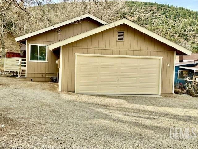 garage with gravel driveway