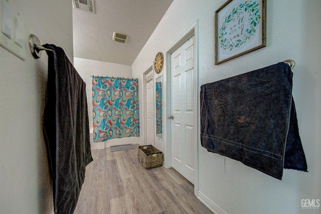 bathroom featuring walk in shower and hardwood / wood-style flooring