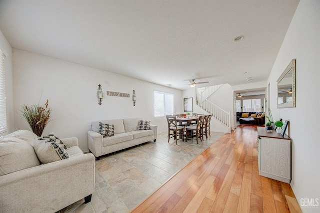 living room with ceiling fan and light hardwood / wood-style floors