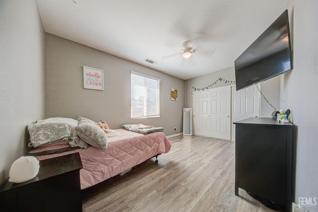 bedroom with light wood-type flooring and ceiling fan