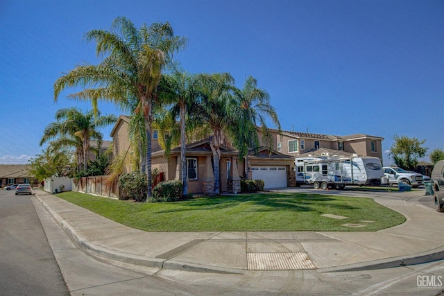 view of front of property with a front yard and a garage