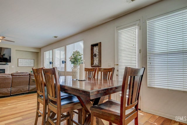 dining area featuring ceiling fan and light wood-type flooring