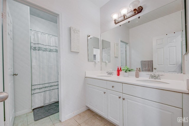 bathroom with a shower with shower curtain, vanity, and tile patterned floors