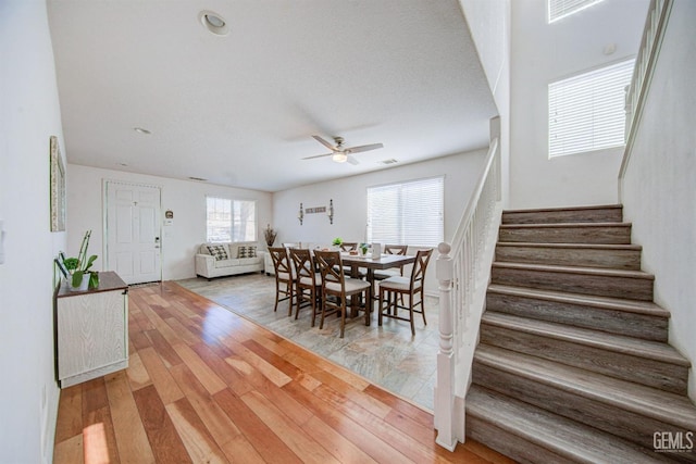 dining area with hardwood / wood-style flooring and ceiling fan