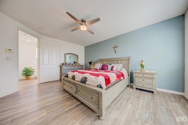 bedroom with light hardwood / wood-style floors and ceiling fan