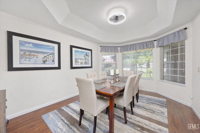 2505 Oak Crest Ct, Bakersfield, CA 93311 - dining area featuring a tray ceiling and wood finished floors
