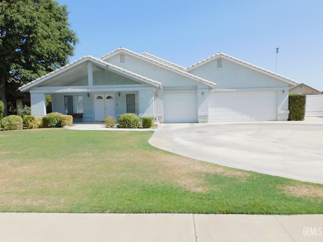 view of front of house featuring a garage and a front lawn