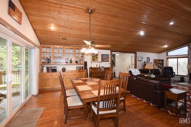 dining room featuring ceiling fan, light hardwood / wood-style floors, lofted ceiling, and wood ceiling