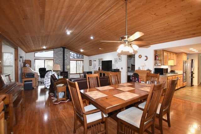 dining room featuring wood ceiling, light hardwood / wood-style flooring, and vaulted ceiling