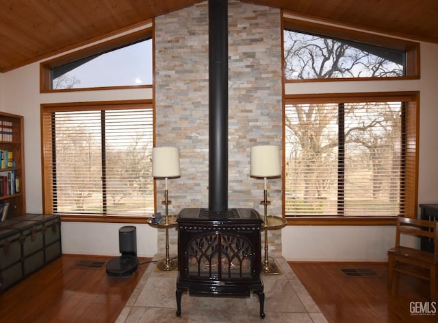 interior details featuring a wood stove, wooden ceiling, and hardwood / wood-style flooring